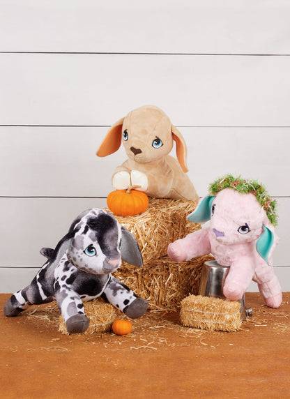 Simplicity S3121 pattern envelope showing three plush animal soft toys with floppy ears on hay bales