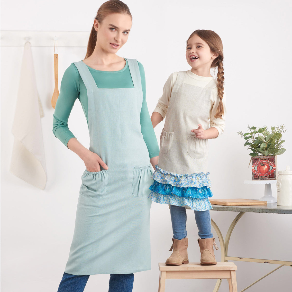 Simplicity S9436 sewing pattern envelope showing crossback aprons