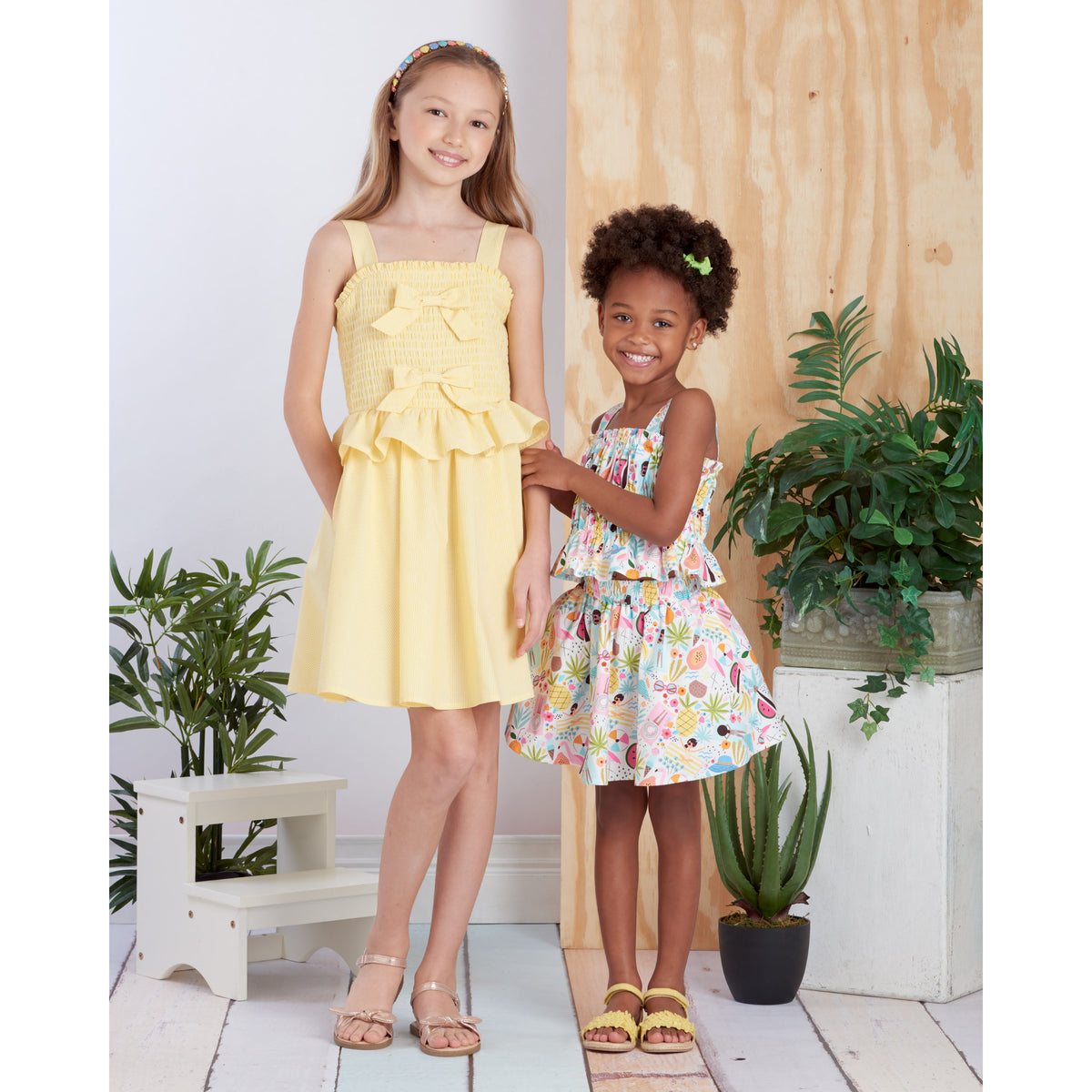 Simplicity S9560 pattern envelope showing girls' tops with ruffle peplums