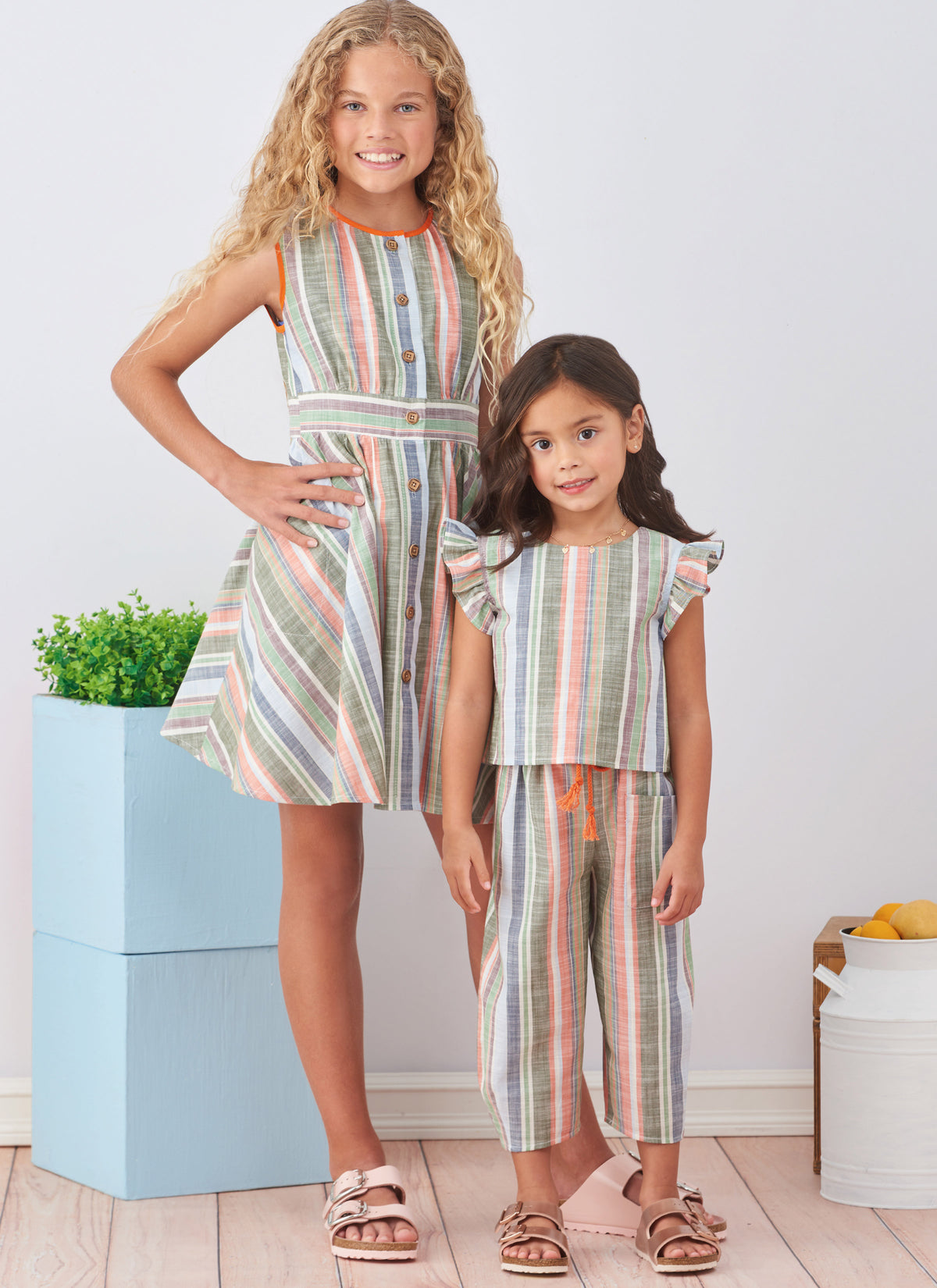 Simplicity S9761 sewing pattern envelope showing a dress, top and trousers