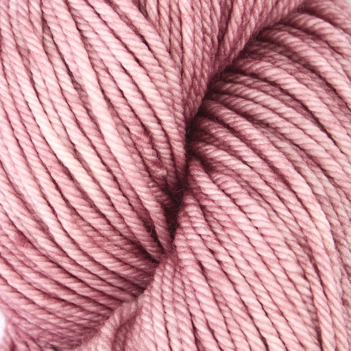 Skein of Symfonie Bella semi-solid merino yarn in Pink Sandstone