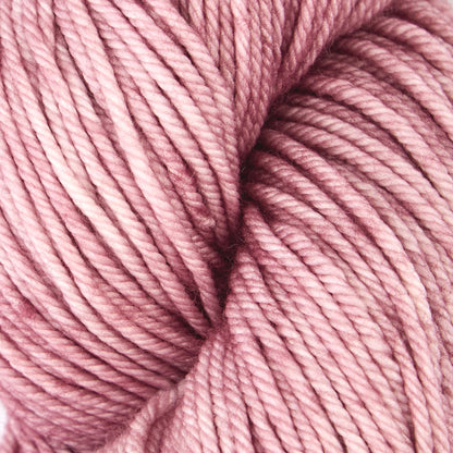 Skein of Symfonie Bella semi-solid merino yarn in Pink Sandstone