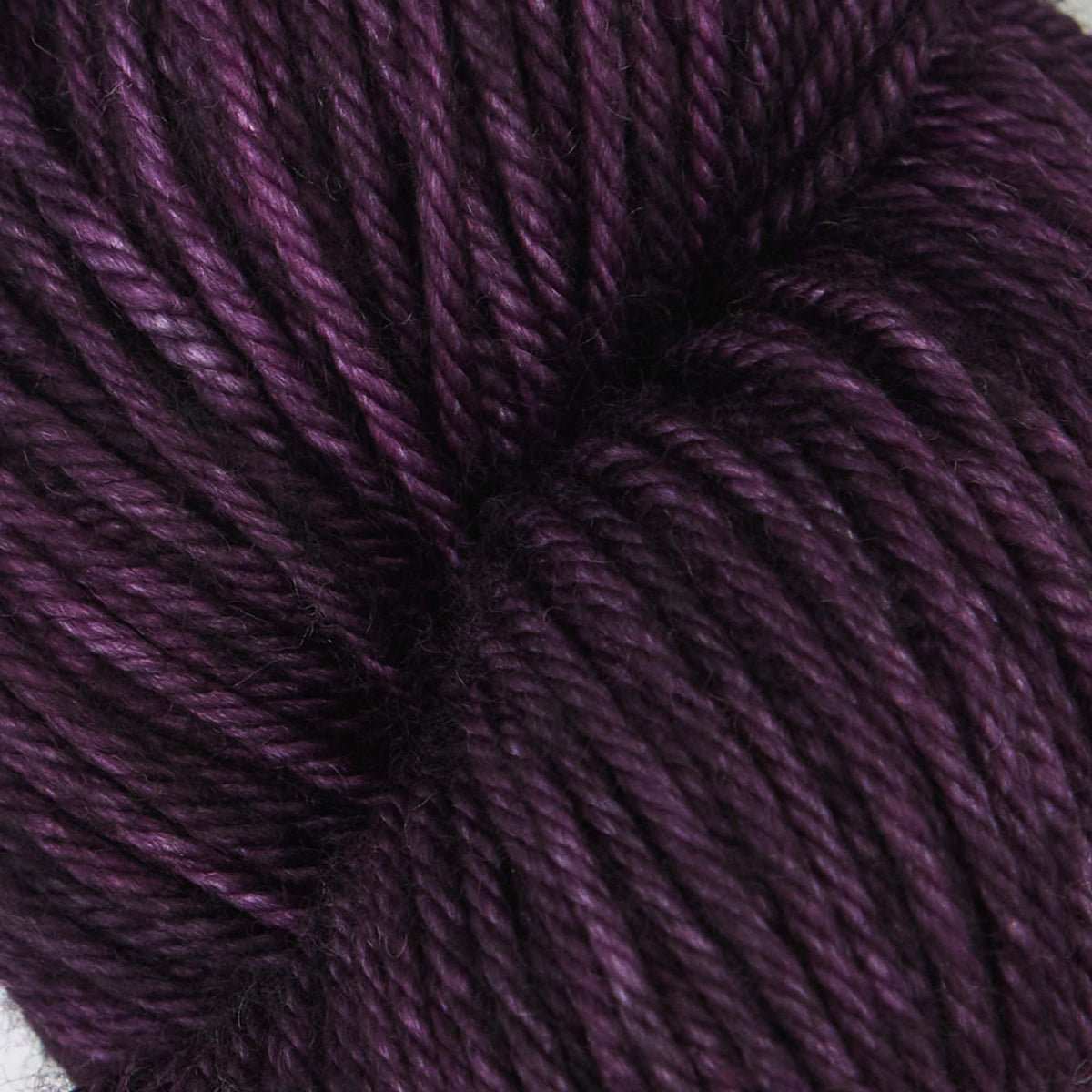 Skein of Symfonie Bella semi-solid merino yarn in Java Plum
