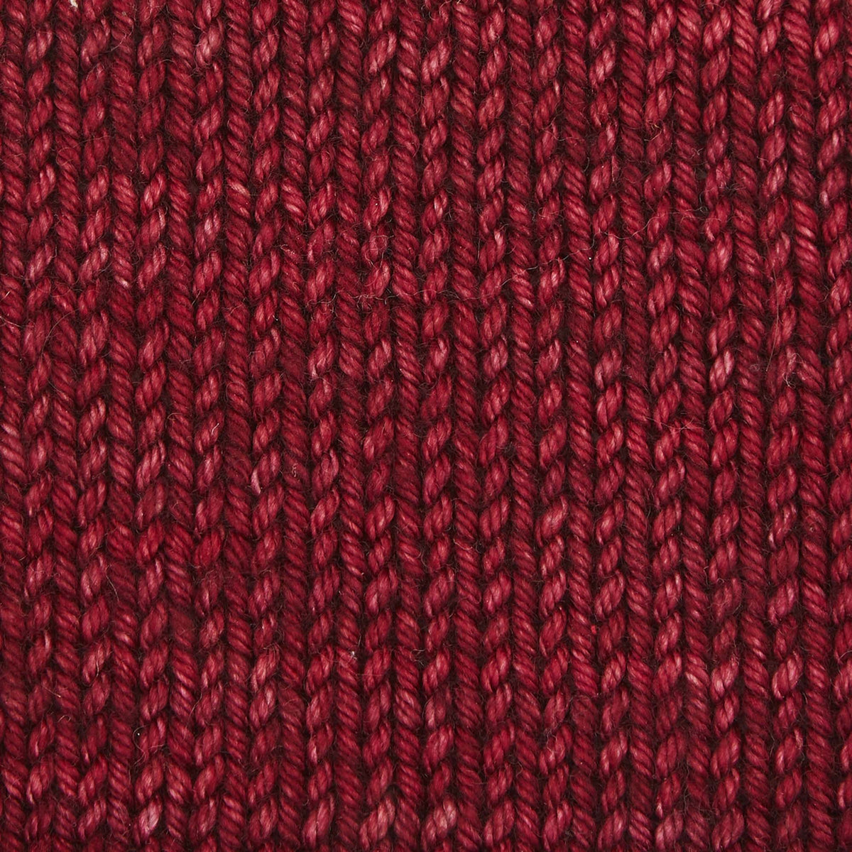Skein of Symfonie Bella semi-solid merino yarn in Dried Chiles
