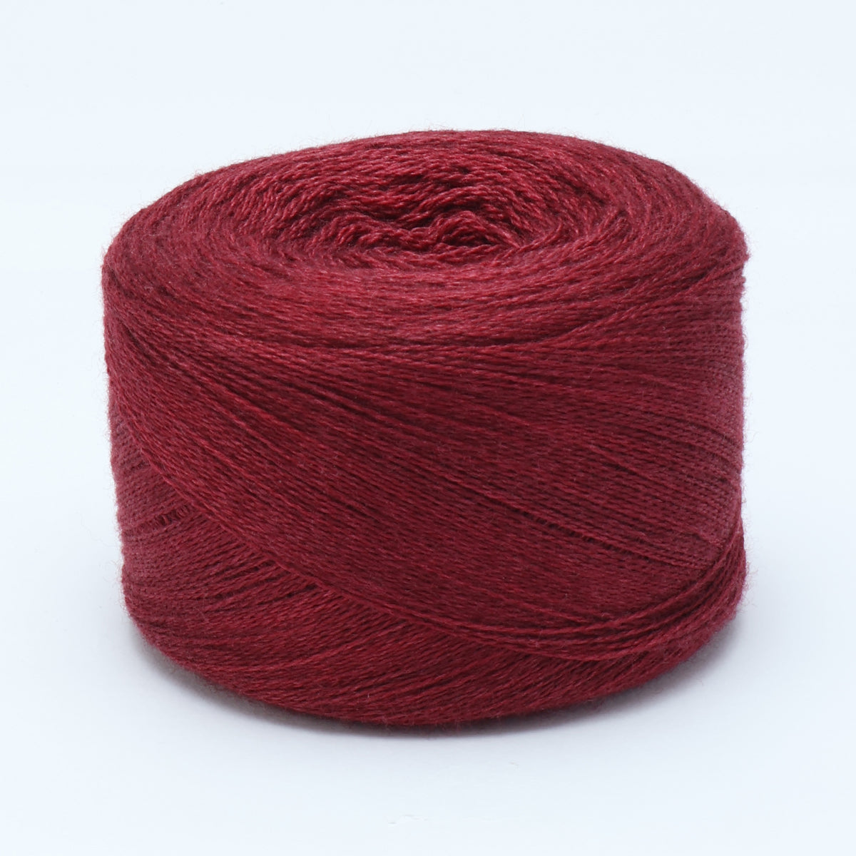 Hand-dyed cake of Symfonie Diva yarn in Red Fall