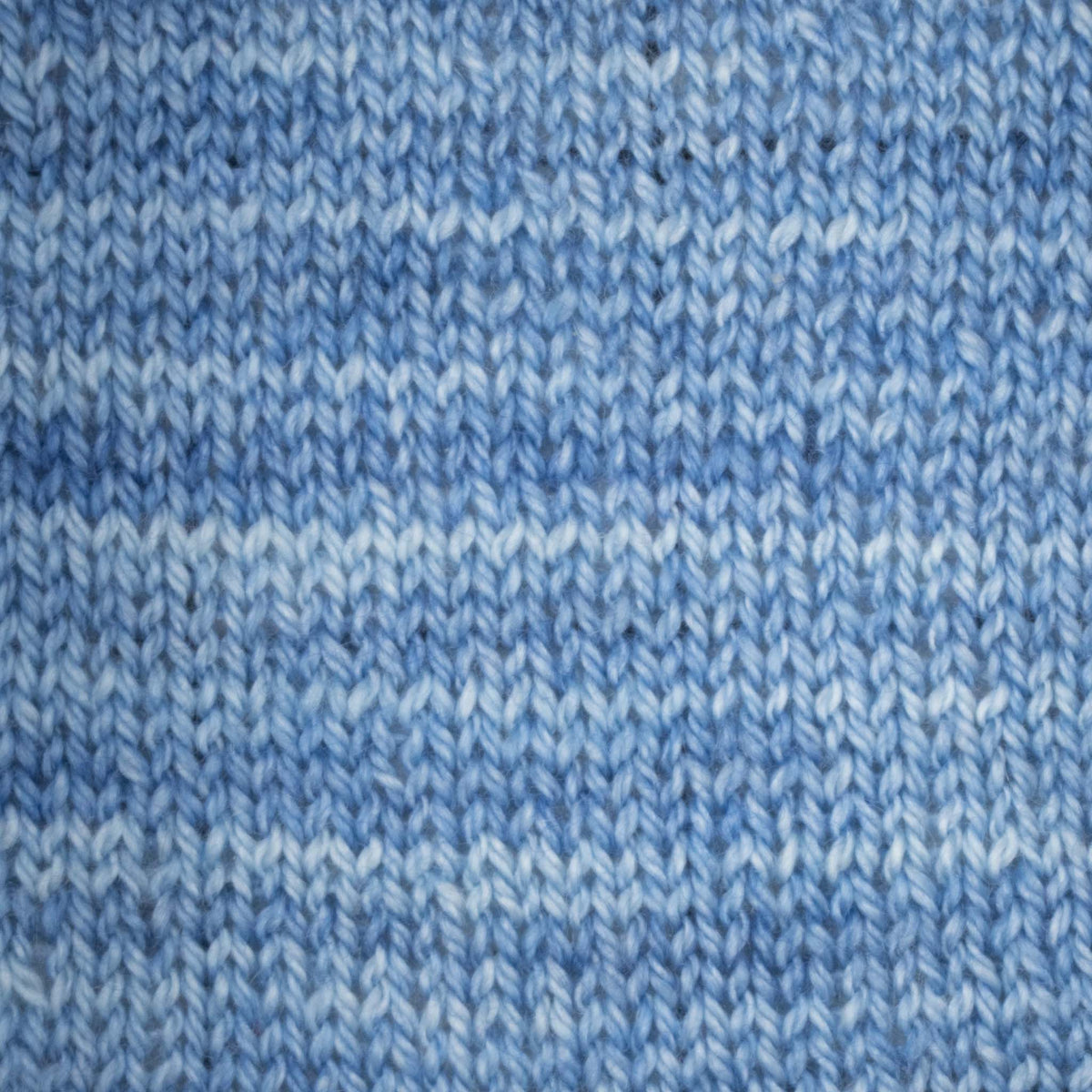 Hand-dyed cake of Symfonie Diva yarn in Blue Topaz