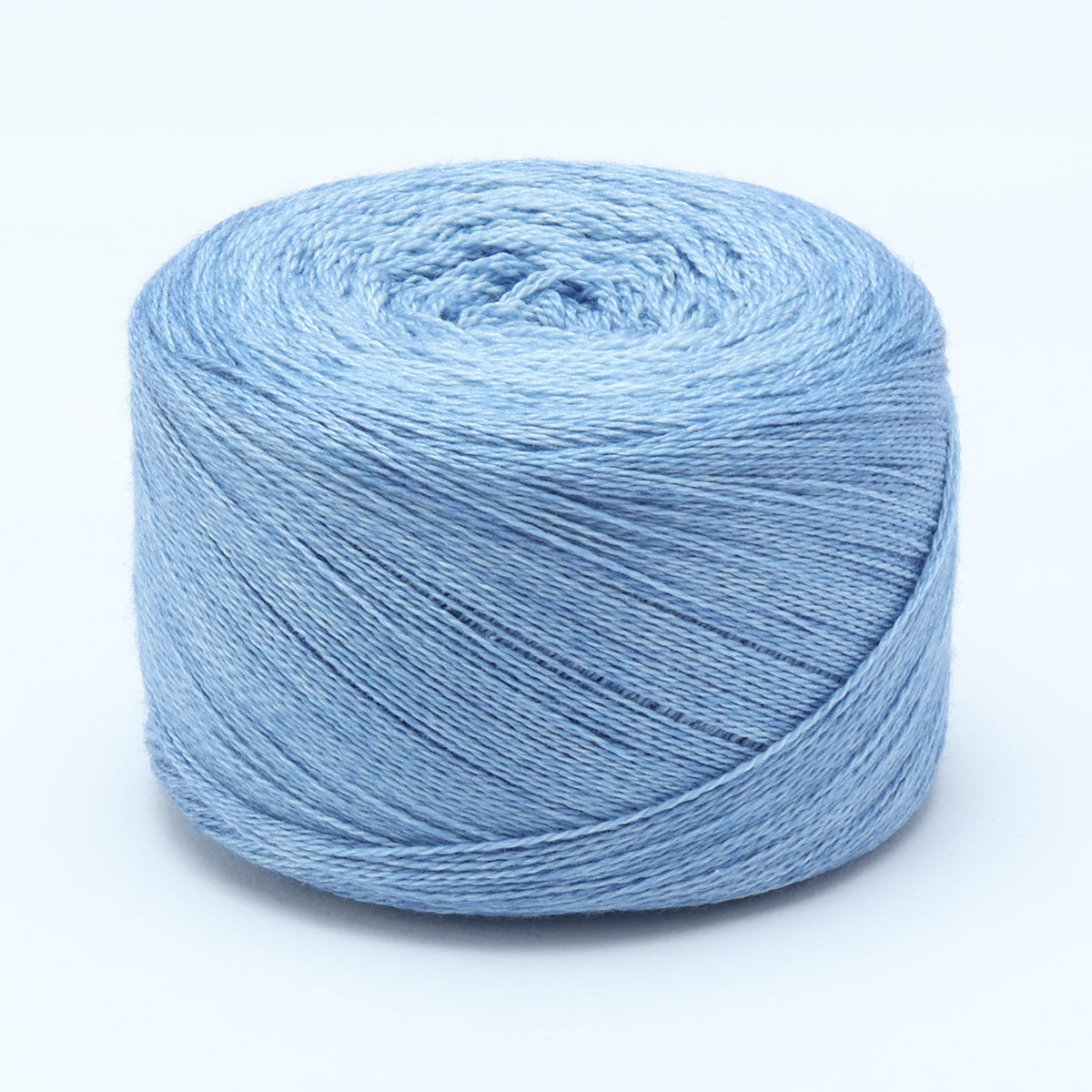 Hand-dyed cake of Symfonie Diva yarn in Blue Topaz