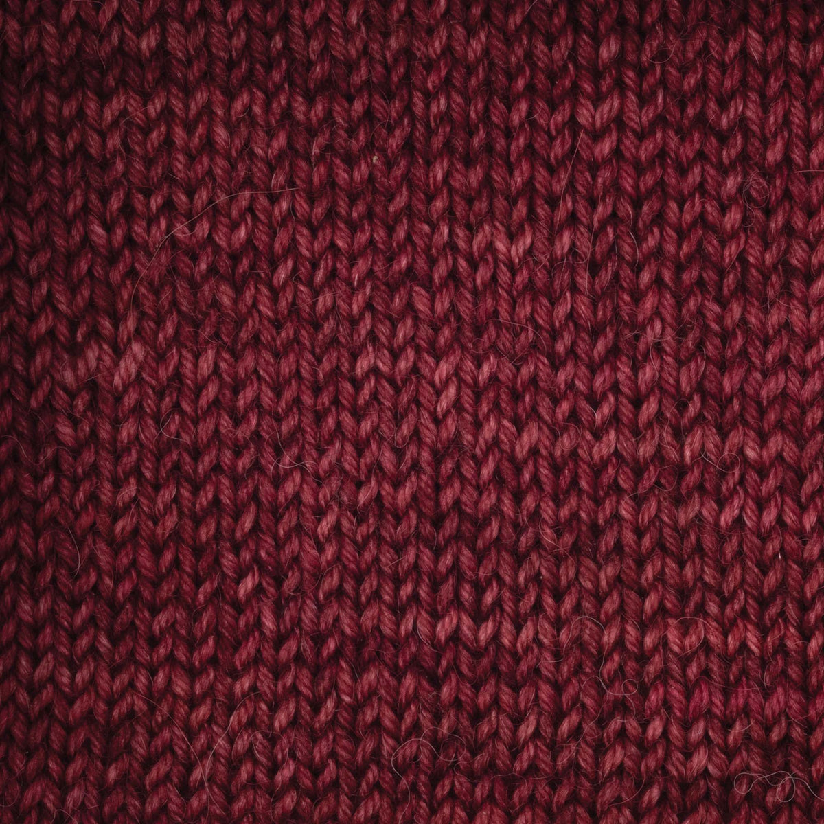 100g skein of Symfonie Serra yarn in Red Fall
