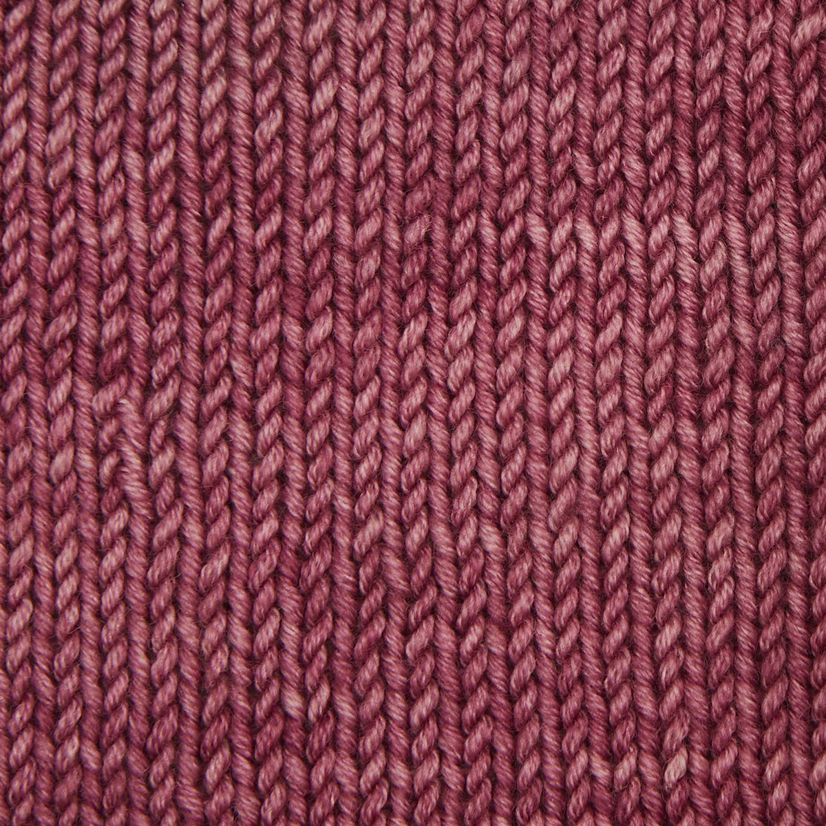 Skein of Symfonie Viva DK merino yarn in Bougainvillea