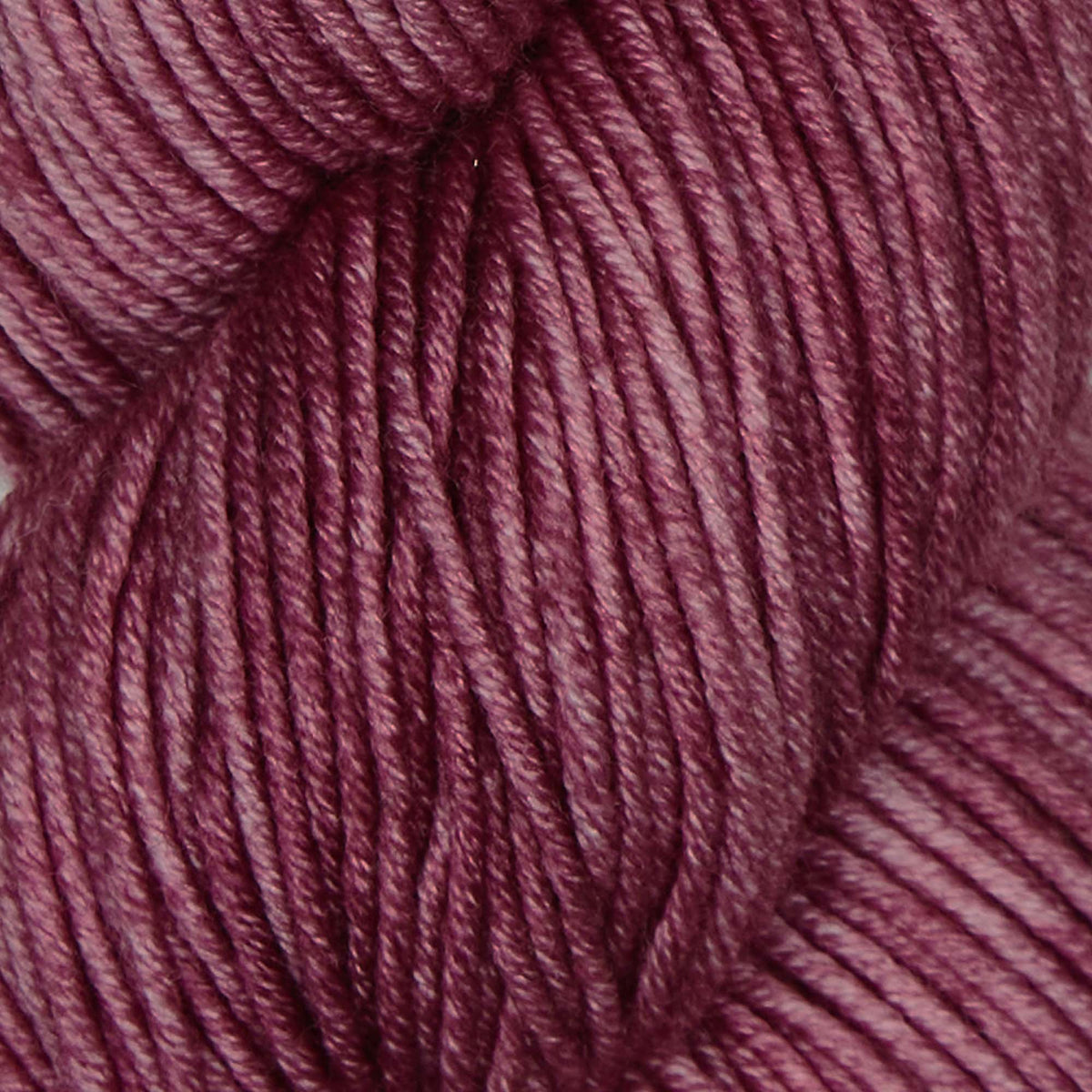 Skein of Symfonie Viva DK merino yarn in Bougainvillea