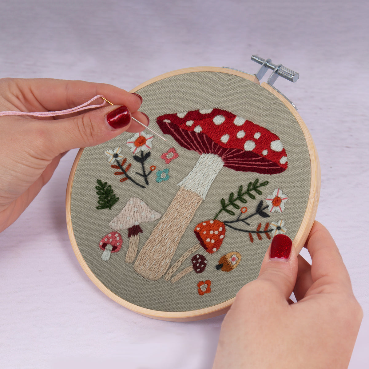 Embroidery hoop kit showing a stitched toadstool design