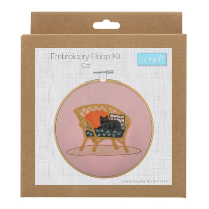 Embroidery hoop kit showing a stitched cat on wicker chair design