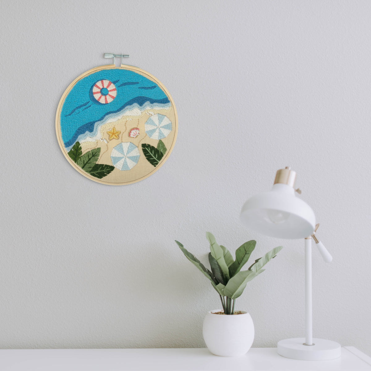 Embroidery hoop kit showing a stitched beach design