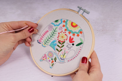 Embroidery hoop kit showing a stitched elephants design