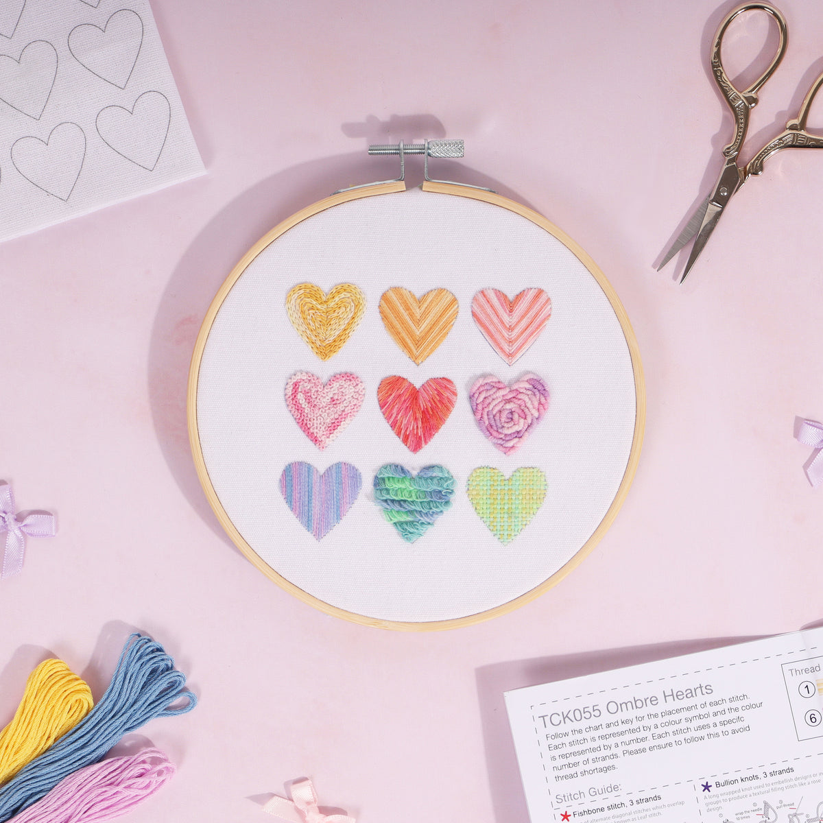 Embroidery hoop kit showing a stitched ombre hearts design