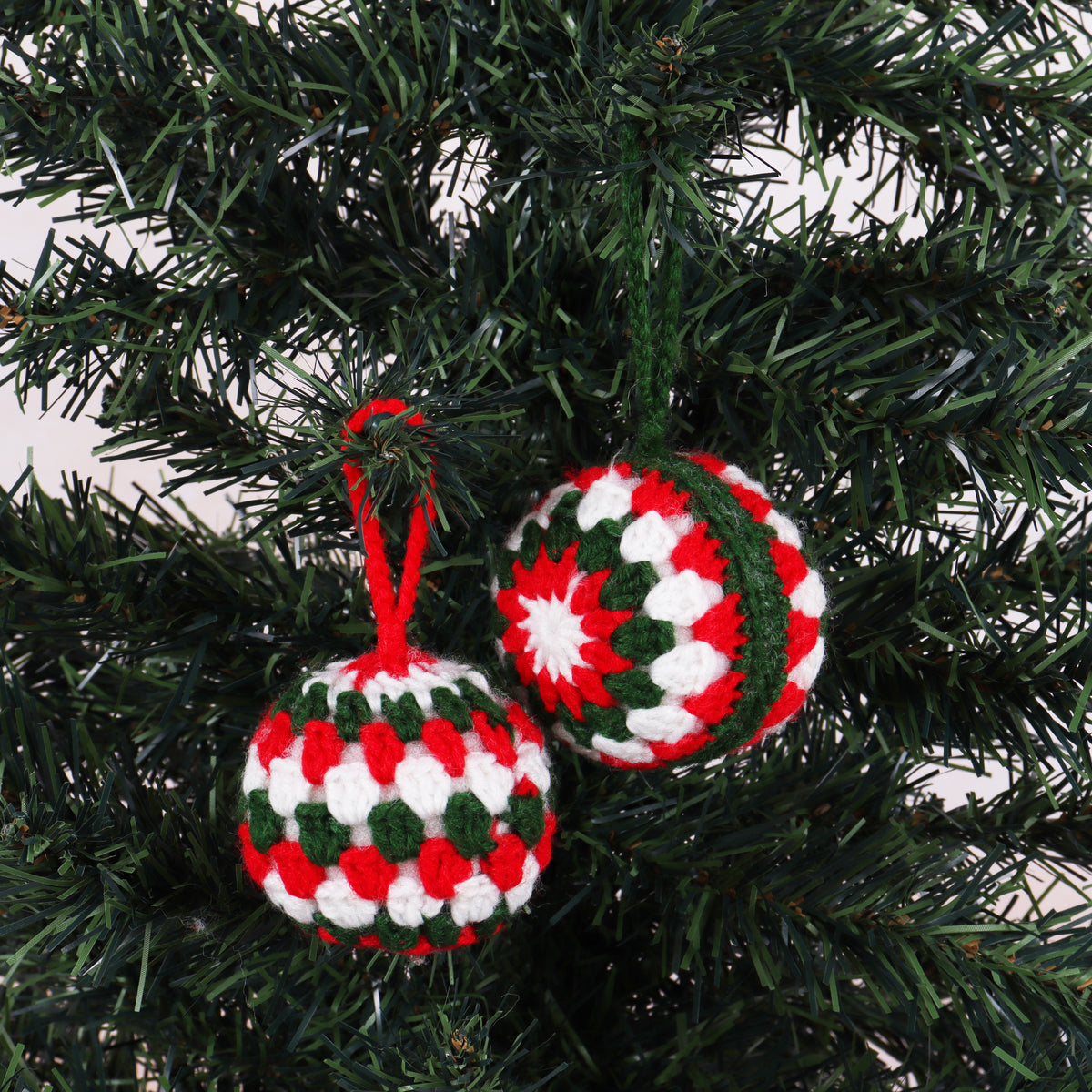 Two crocheted festive bauble decorations