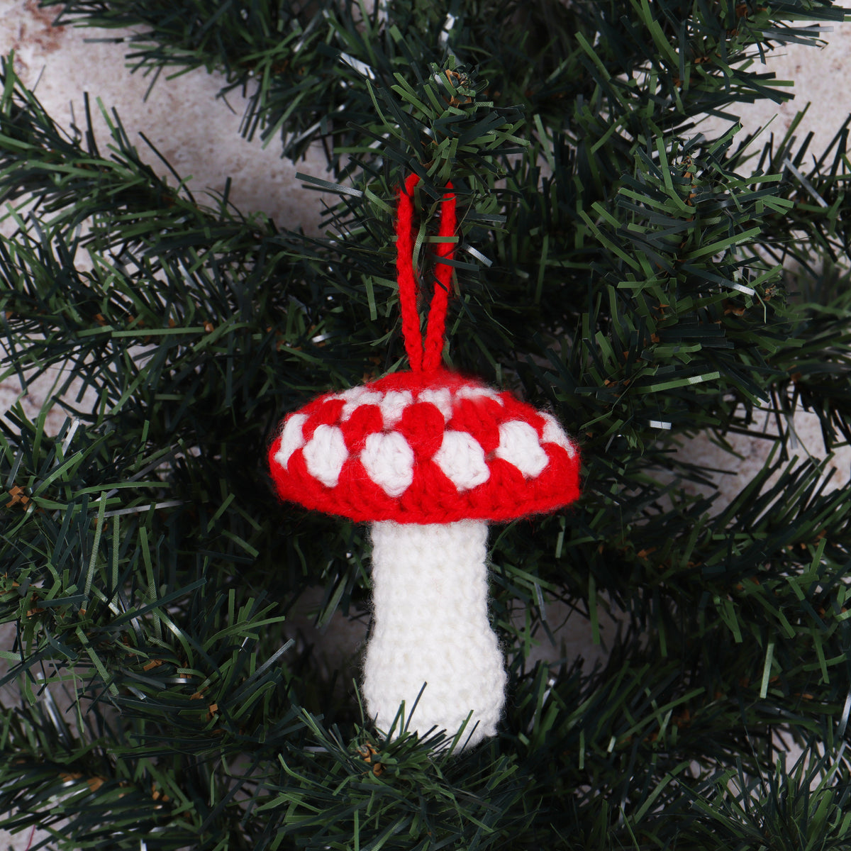 Crocheted red and white toadstool