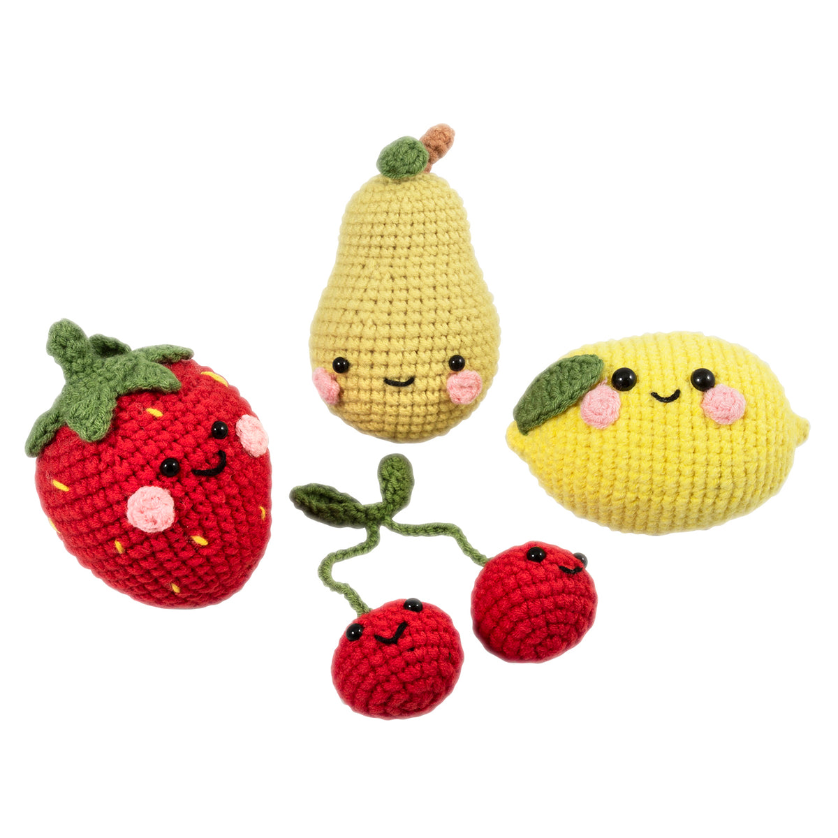 Four crocheted amigurumi fruits with smiley faces
