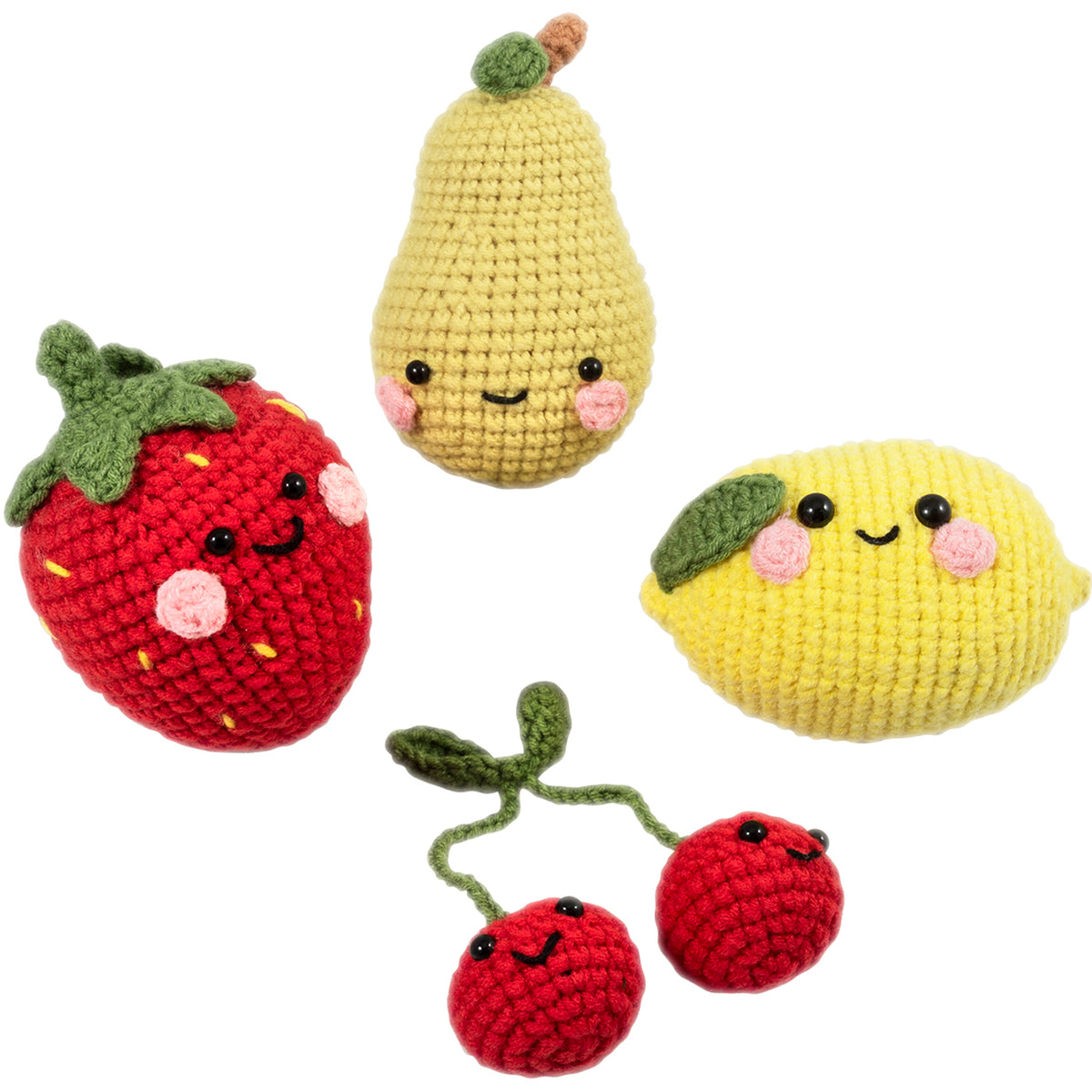 Four crocheted amigurumi fruits with smiley faces
