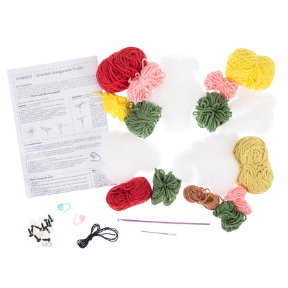 Four crocheted amigurumi fruits with smiley faces