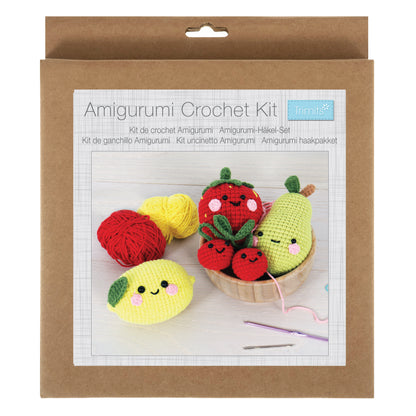 Four crocheted amigurumi fruits with smiley faces