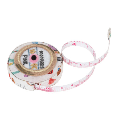 Round fabric-covered retractable tape measure with haberdashery notions print
