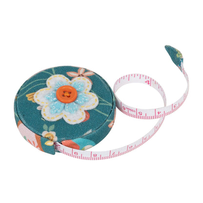 Round fabric-covered retractable tape measure with applique bird design