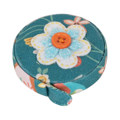 Round fabric-covered retractable tape measure with applique bird design