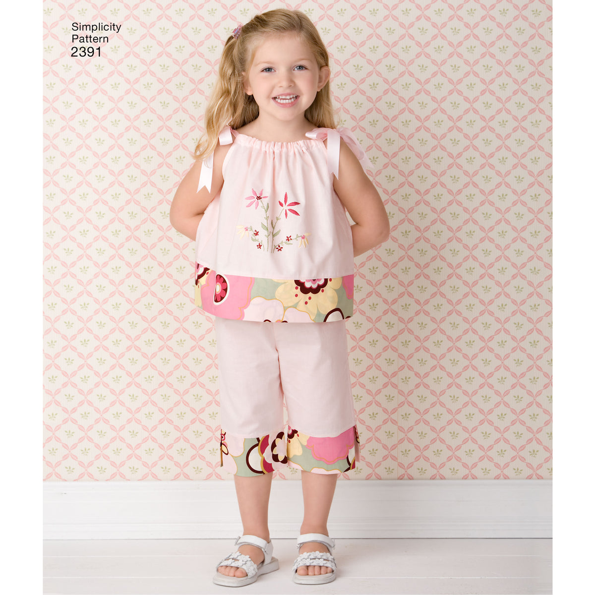 Simplicity S2391 sewing pattern envelope showing child's dress, tops, trousers and bag