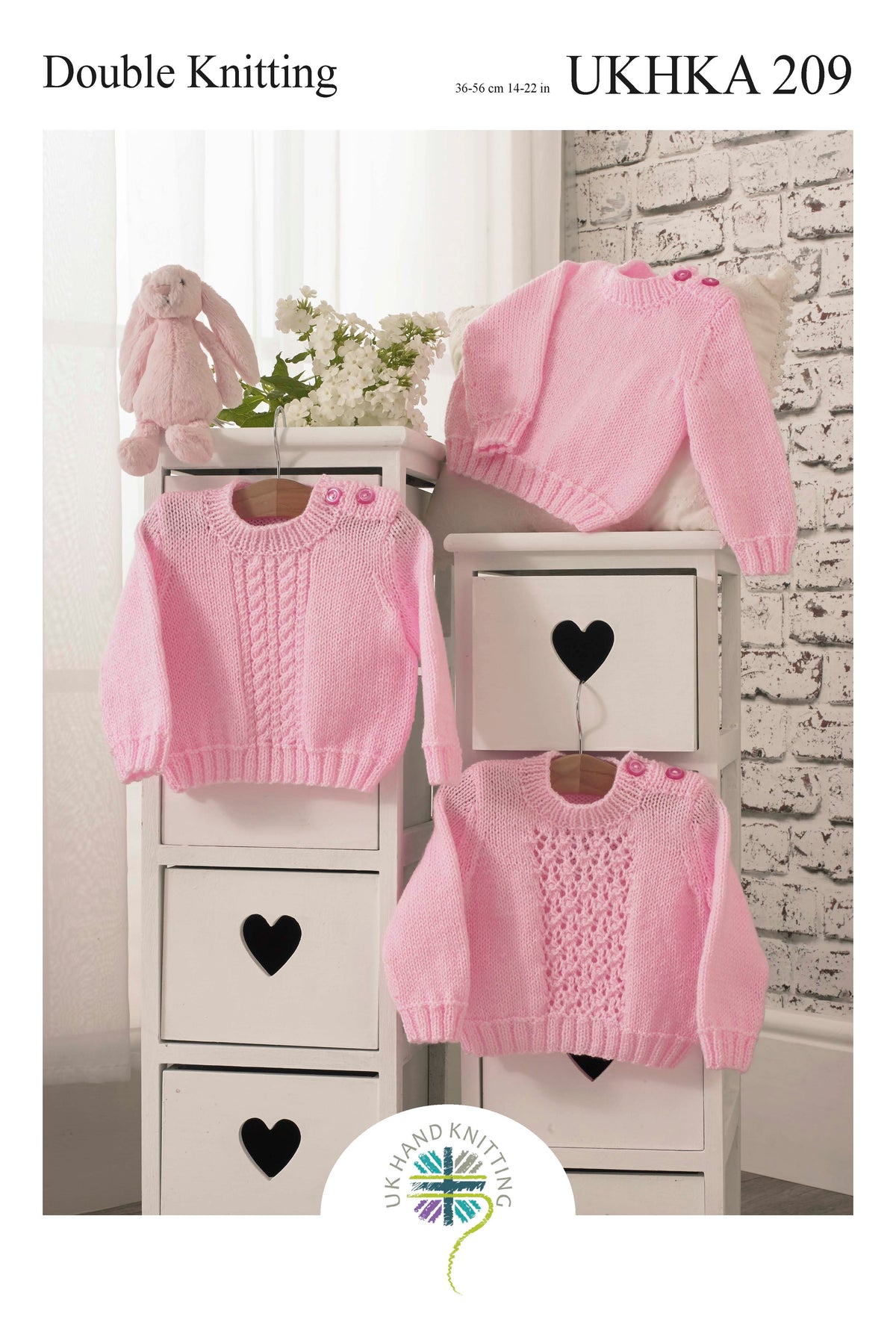 Knitting pattern cover showing children's knitted sweaters