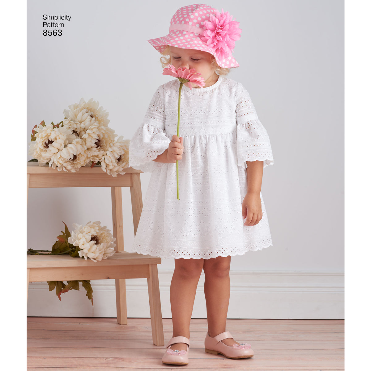 Simplicity sewing pattern S8563 envelope showing toddler dresses and hat