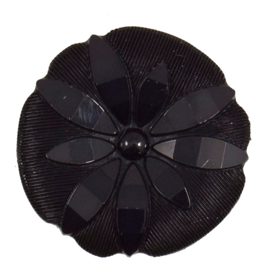 Round black shank button with raised flower design, 25mm